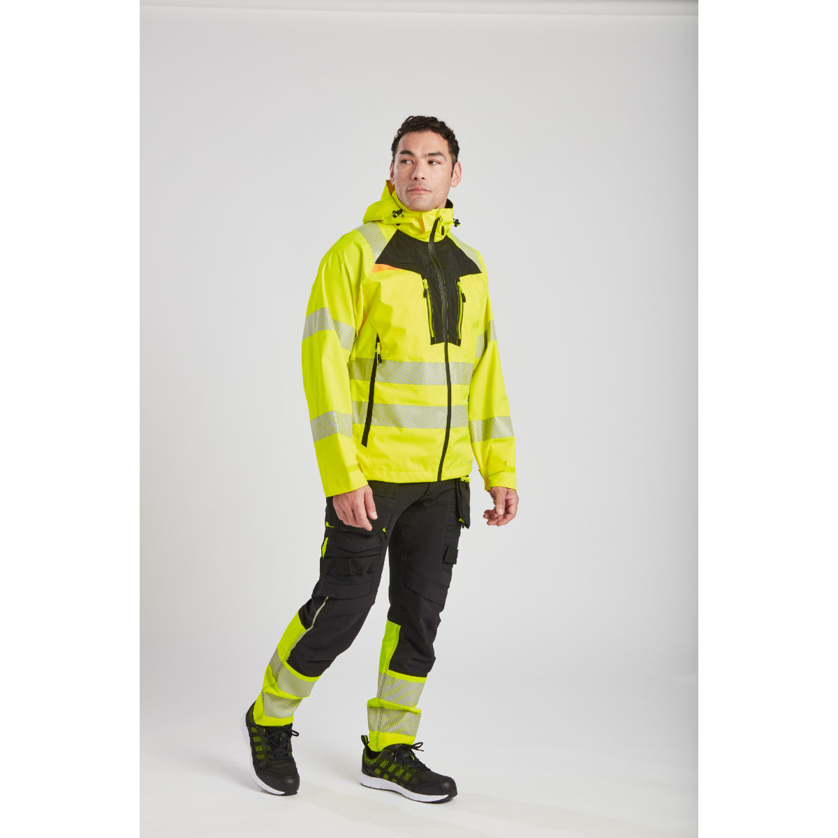Worker confidently wearing the Portwest hi-vis rain jacket.