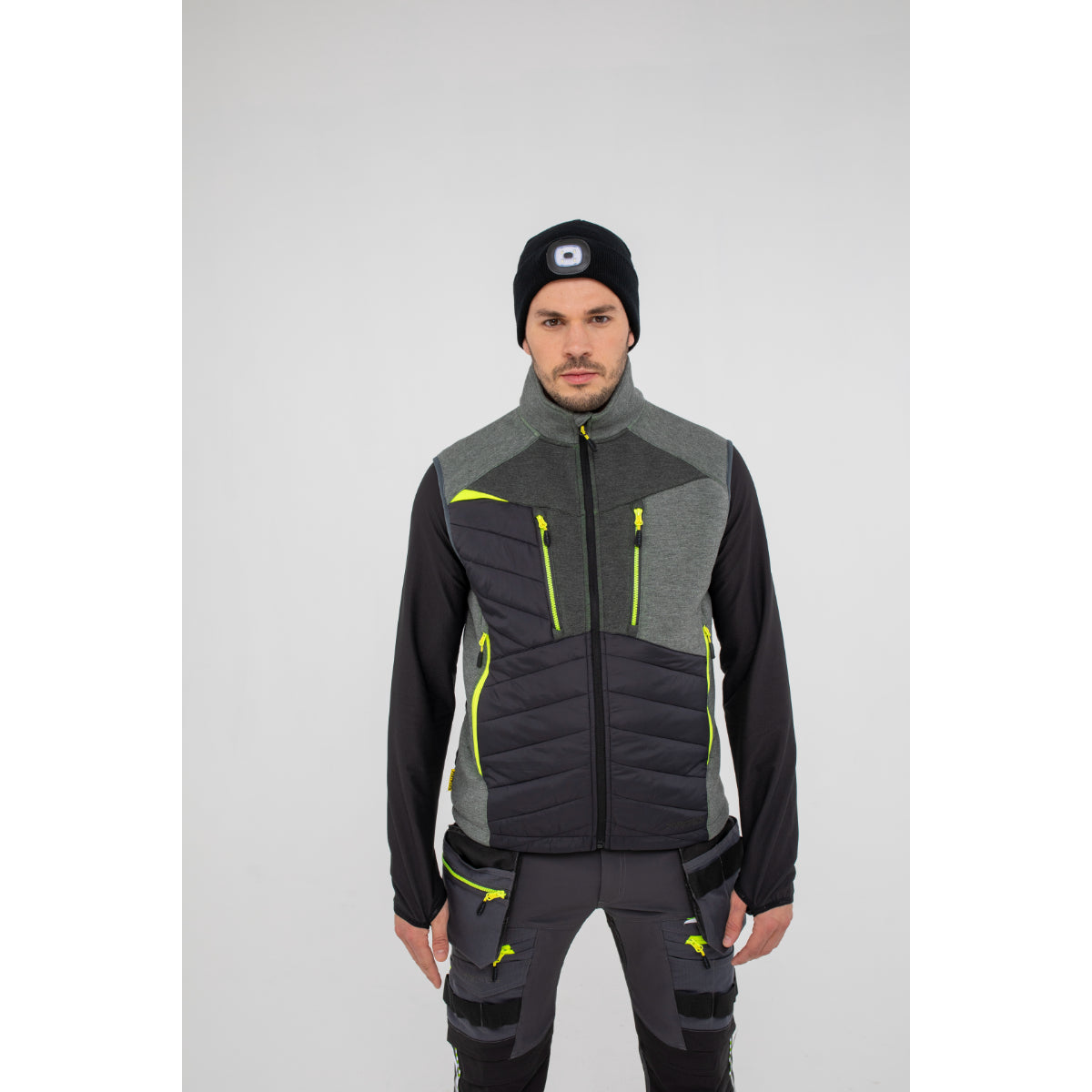 Man in Portwest DX4 Zip Base Layer demonstrating arm flexibility.