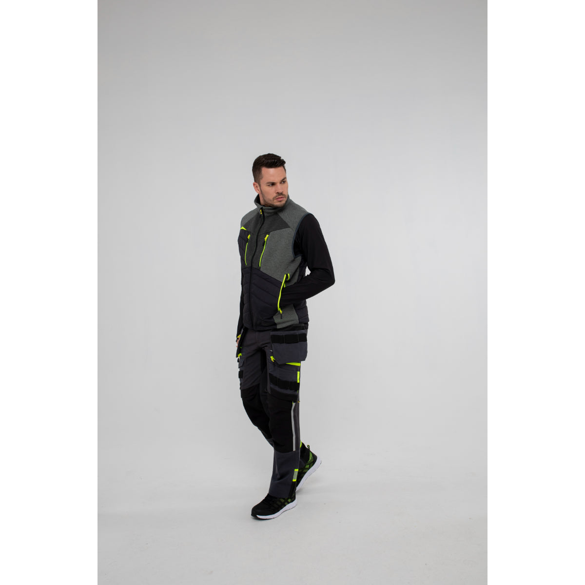Back view of a man in Portwest DX4 Zip Base Layer and gilet showing layered fit.