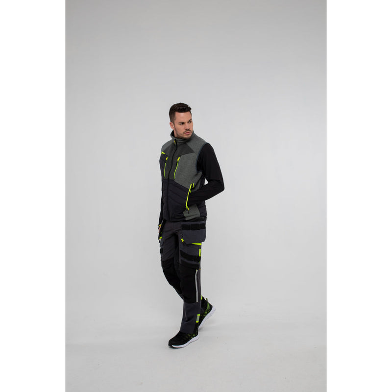 Back view of a man in Portwest DX4 Zip Base Layer and gilet showing layered fit.