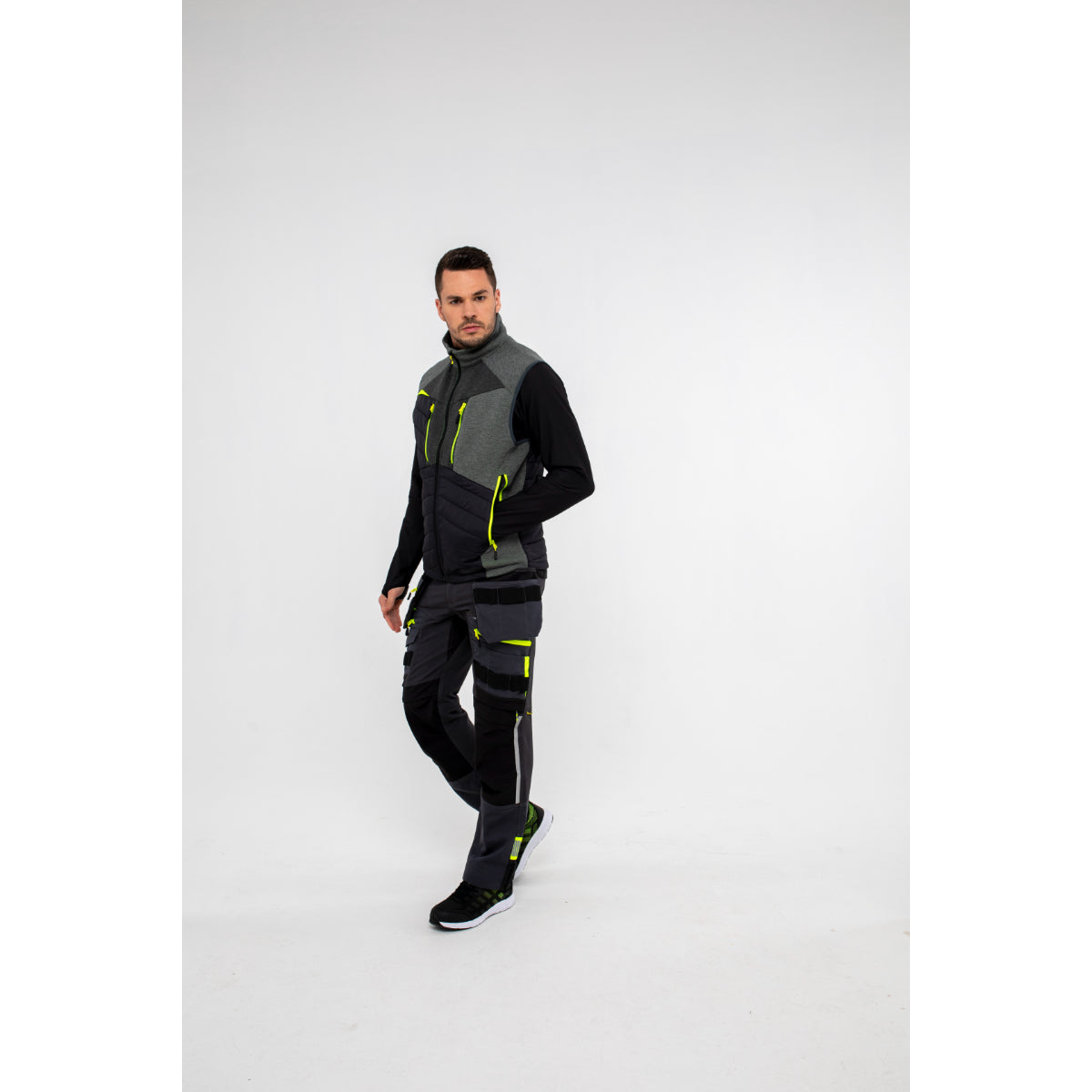 Man in Portwest DX4 Zip Base Layer demonstrating arm stretch and flexibility.