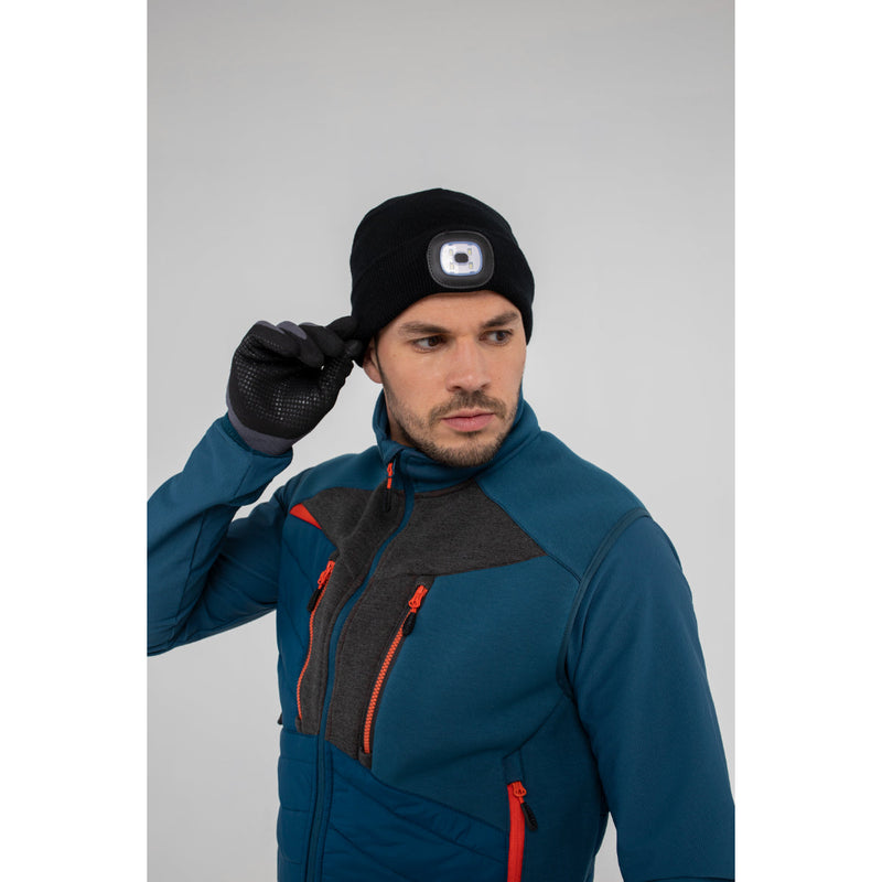 Man in Portwest DX4 Hybrid Baffle Jacket demonstrating active movement.