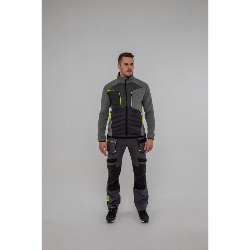 Man wearing a Portwest DX4 Hybrid Baffle Jacket work trousers and safety boots.