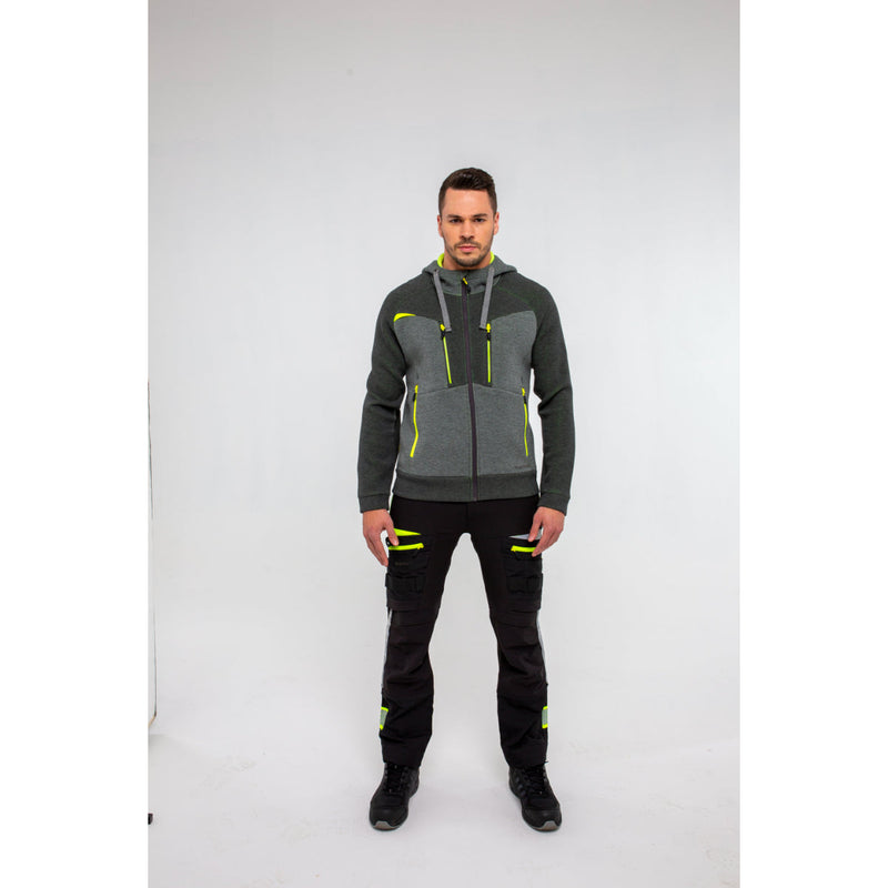 Man in Portwest DX4 Zipped Hoodie and work trousers standing in a warehouse setting.