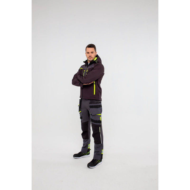 Man in Portwest DX4 Softshell 3L jacket demonstrating arm flexibility.