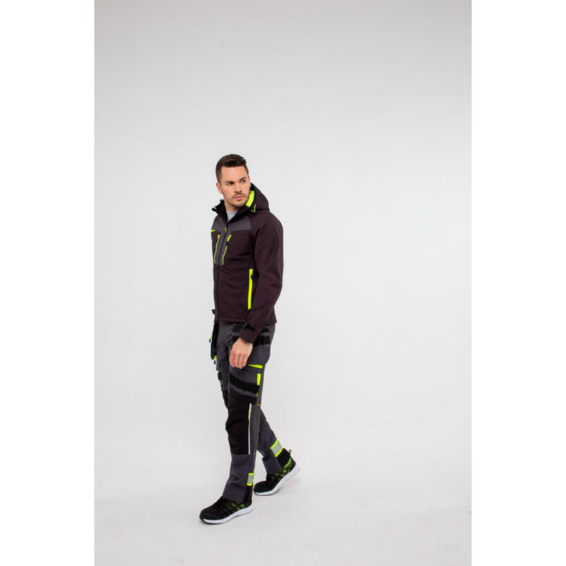 Man in Portwest DX4 Softshell 3L jacket demonstrating reaching overhead flexibility.