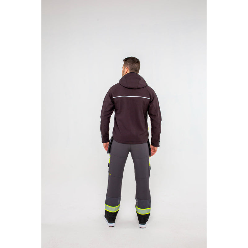 Man in Portwest DX4 Softshell 3L jacket showing the hem and waist adjustability.