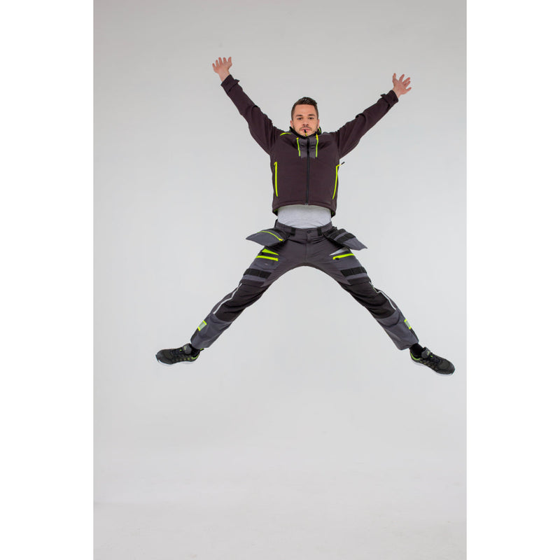Man in Portwest DX4 Softshell 3L jacket demonstrating full range of motion.