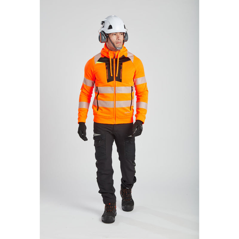 A model in a high-visibility jacket turns to show the Portwest helmet and ear muffs.