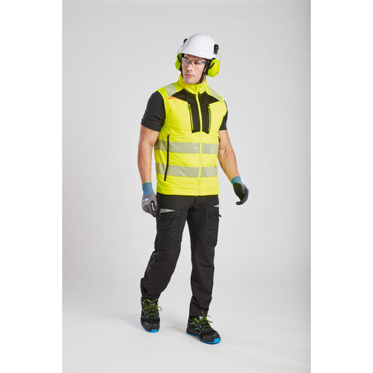 Worker in hi-vis gear operating a machine with NPR Pro gloves.