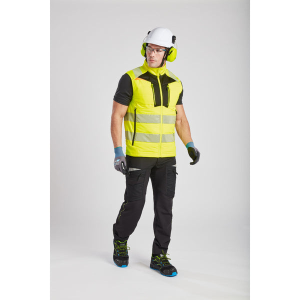Worker in hi-vis gear operating a machine with NPR Pro gloves.