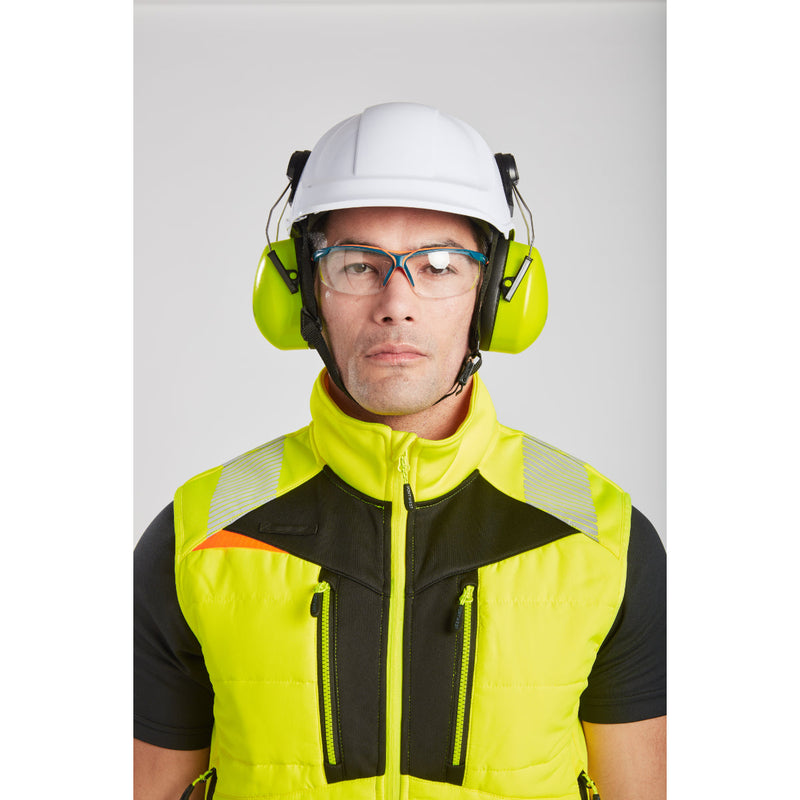 Man in Portwest DX4 Hi-Vis Softshell Bodywarmer standing casually in a field.