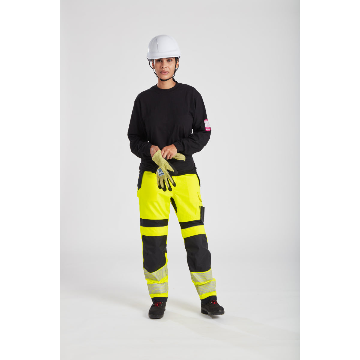 Model displaying side profile of Portwest PW3 FR409 Hi-Vis Women's Work Trousers