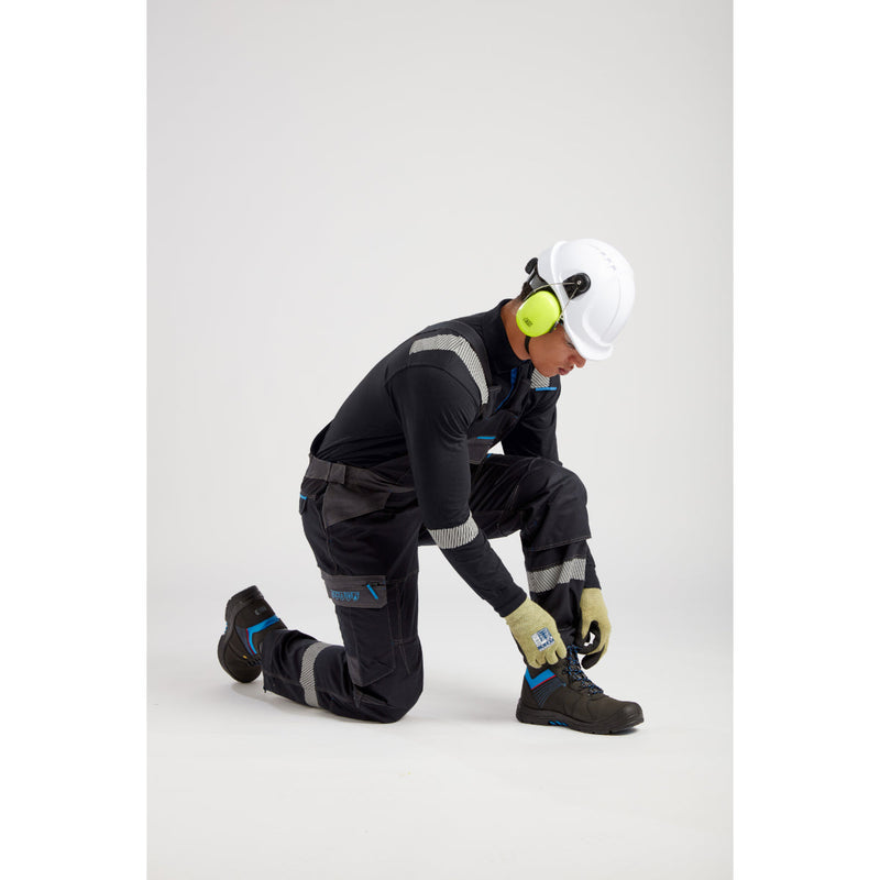 Worker holding a tool, dressed in Portwest safety and FR apparel.