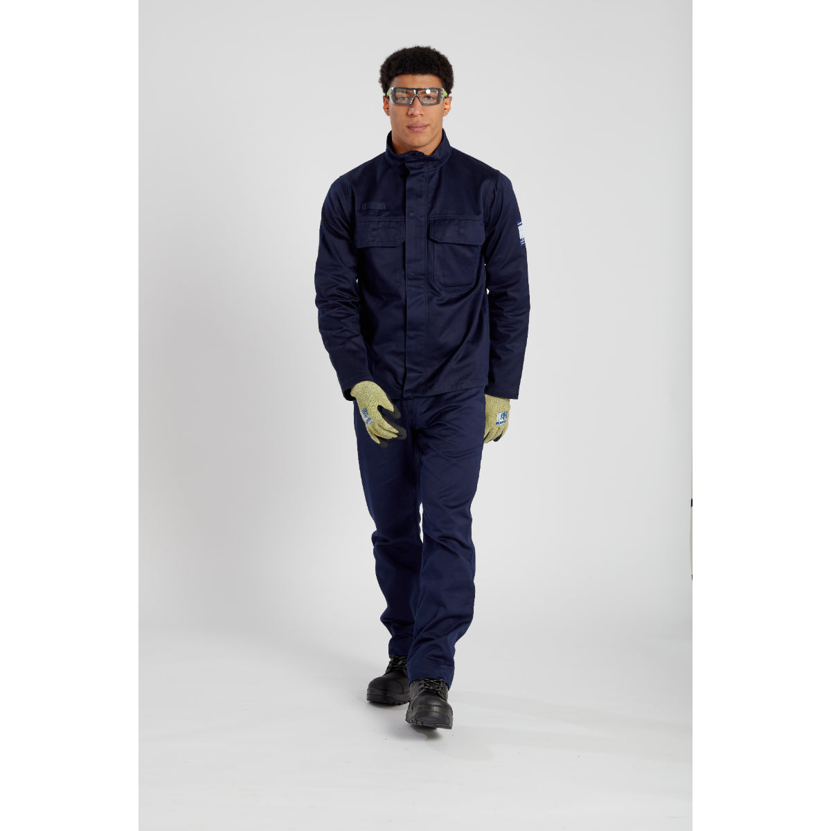 Worker in flame-resistant clothing, with eye safety provided by the Portwest Tech Look Plus Spectacles (PS11).