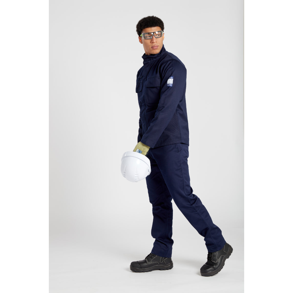 Worker wearing a full set of Portwest FR and PPE gear, including the essential Tech Look Plus Spectacles (PS11).