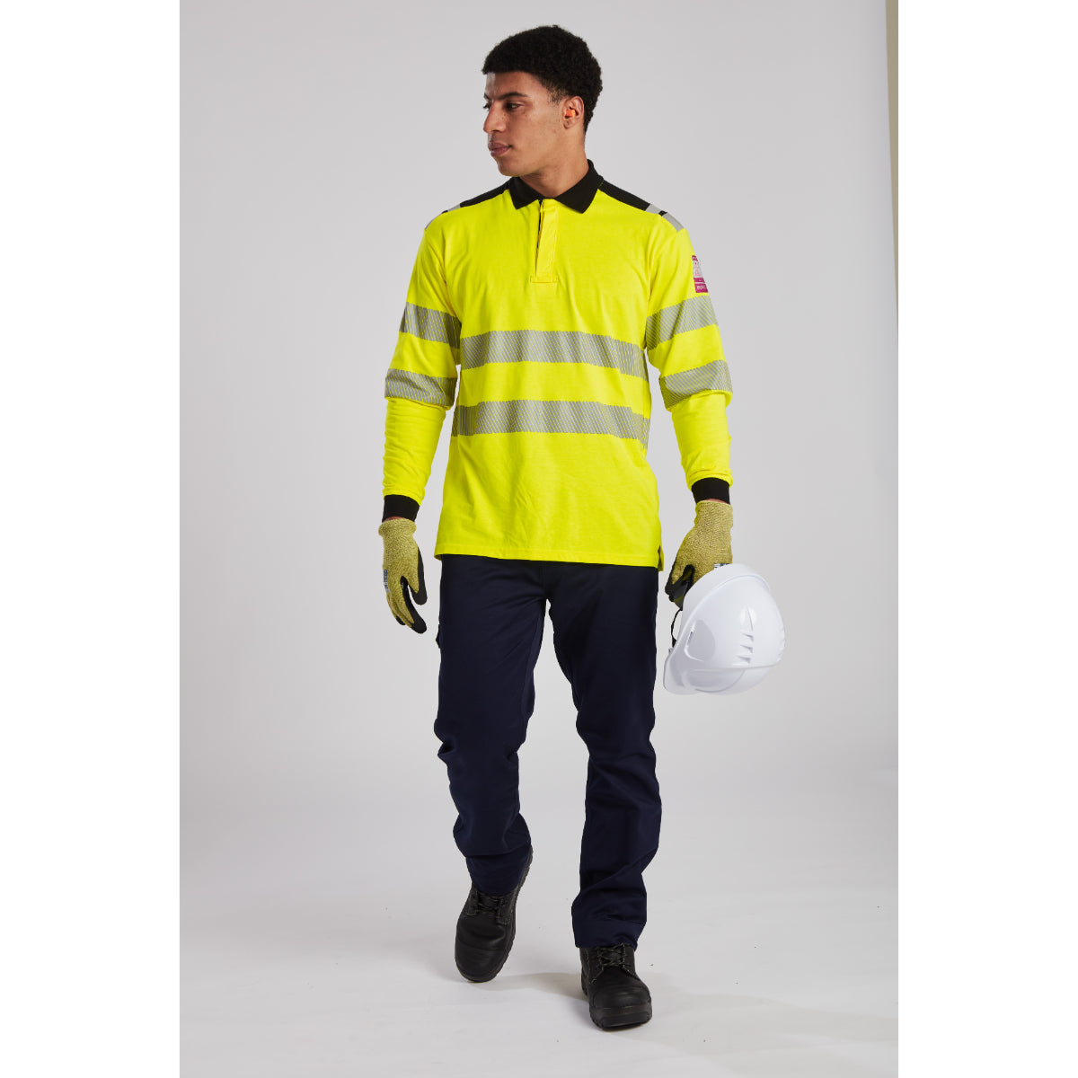 Full body shot of a worker in protective gear, including Portwest ear protection.