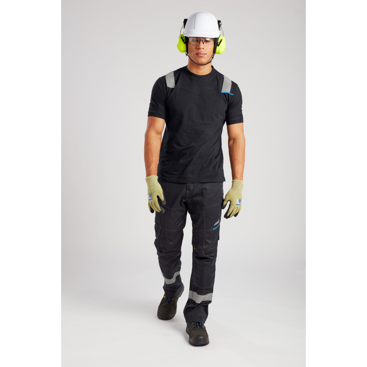 Construction safety gear set with black workwear, white helmet, yellow ear protection and reflective accents