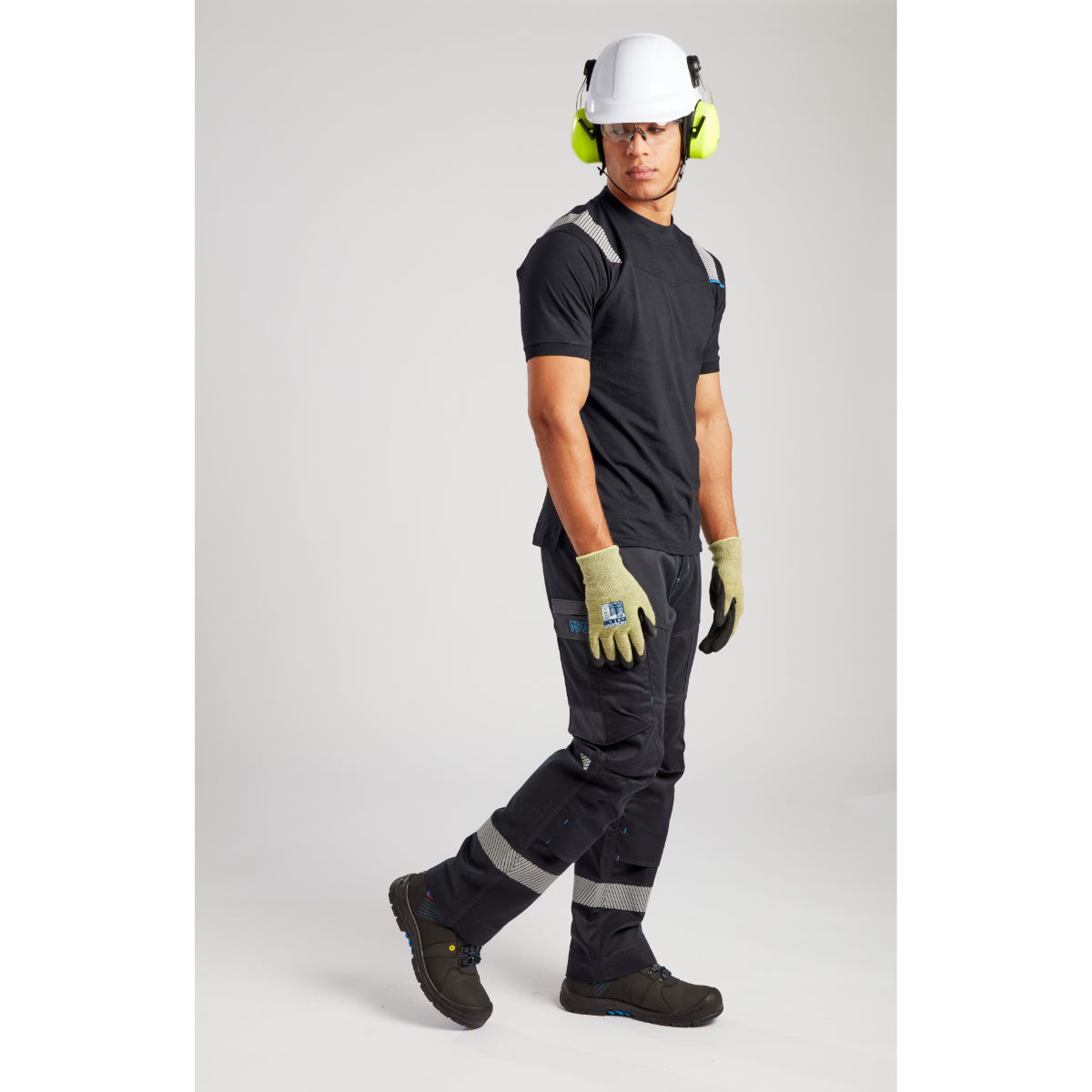 Full safety workwear outfit with hard hat, ear protection, safety glasses and reflective black clothing