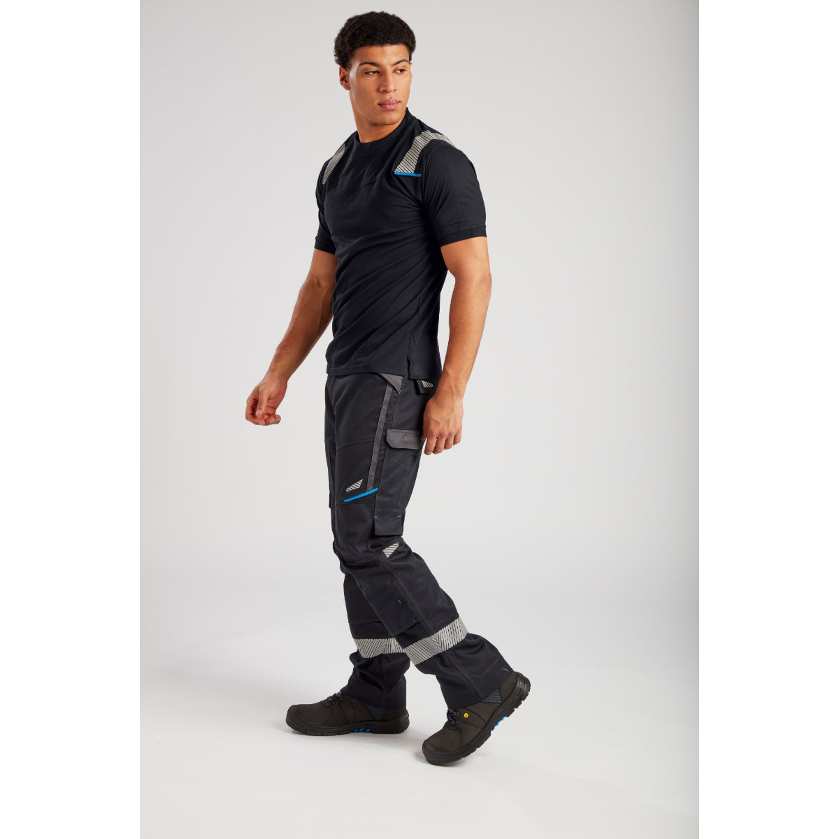 Black tactical cargo pants with multiple pockets and reinforced knees paired with athletic T-shirt and hiking boots