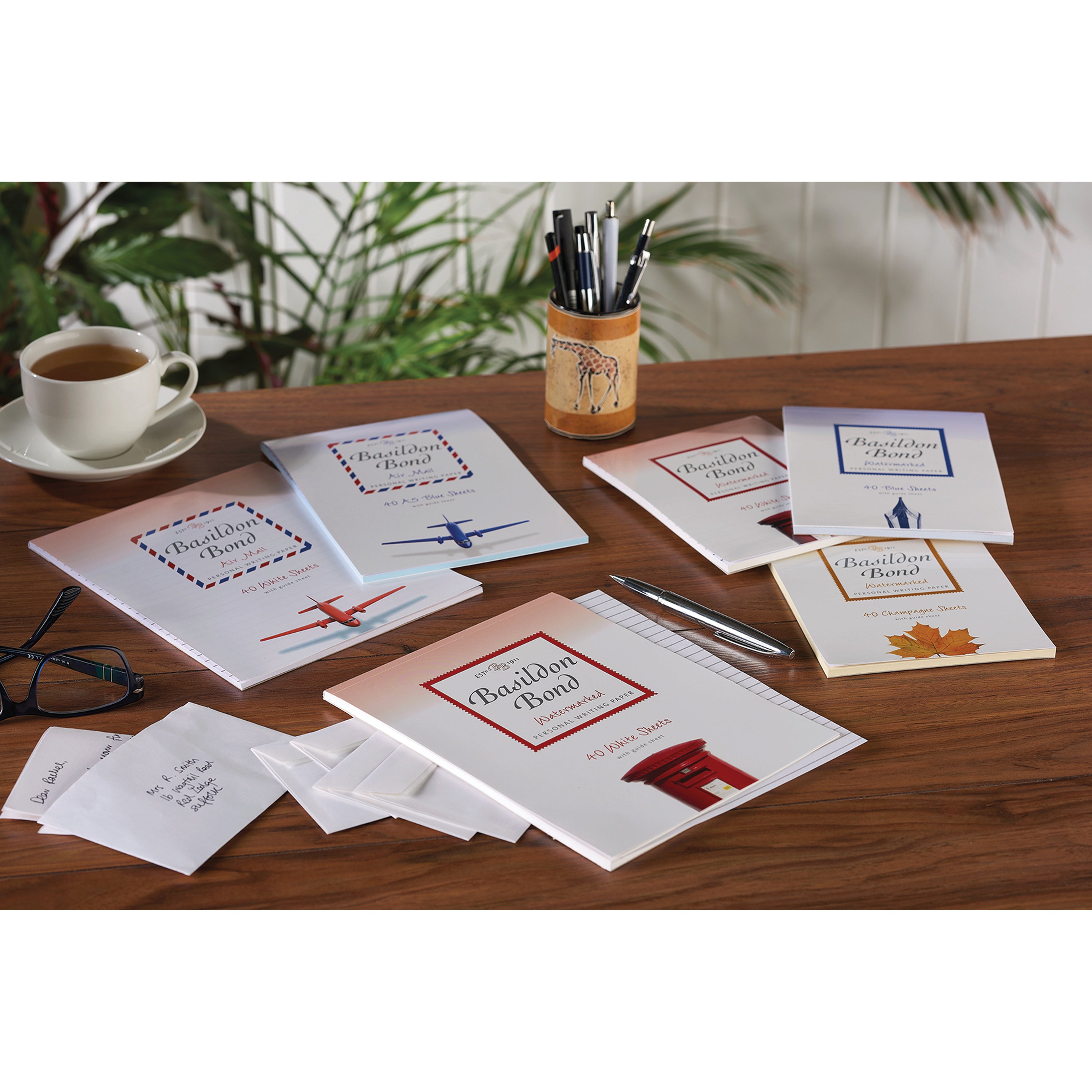 A multi-pack of 10 Basildon Bond white writing pads, showing the value and supply.