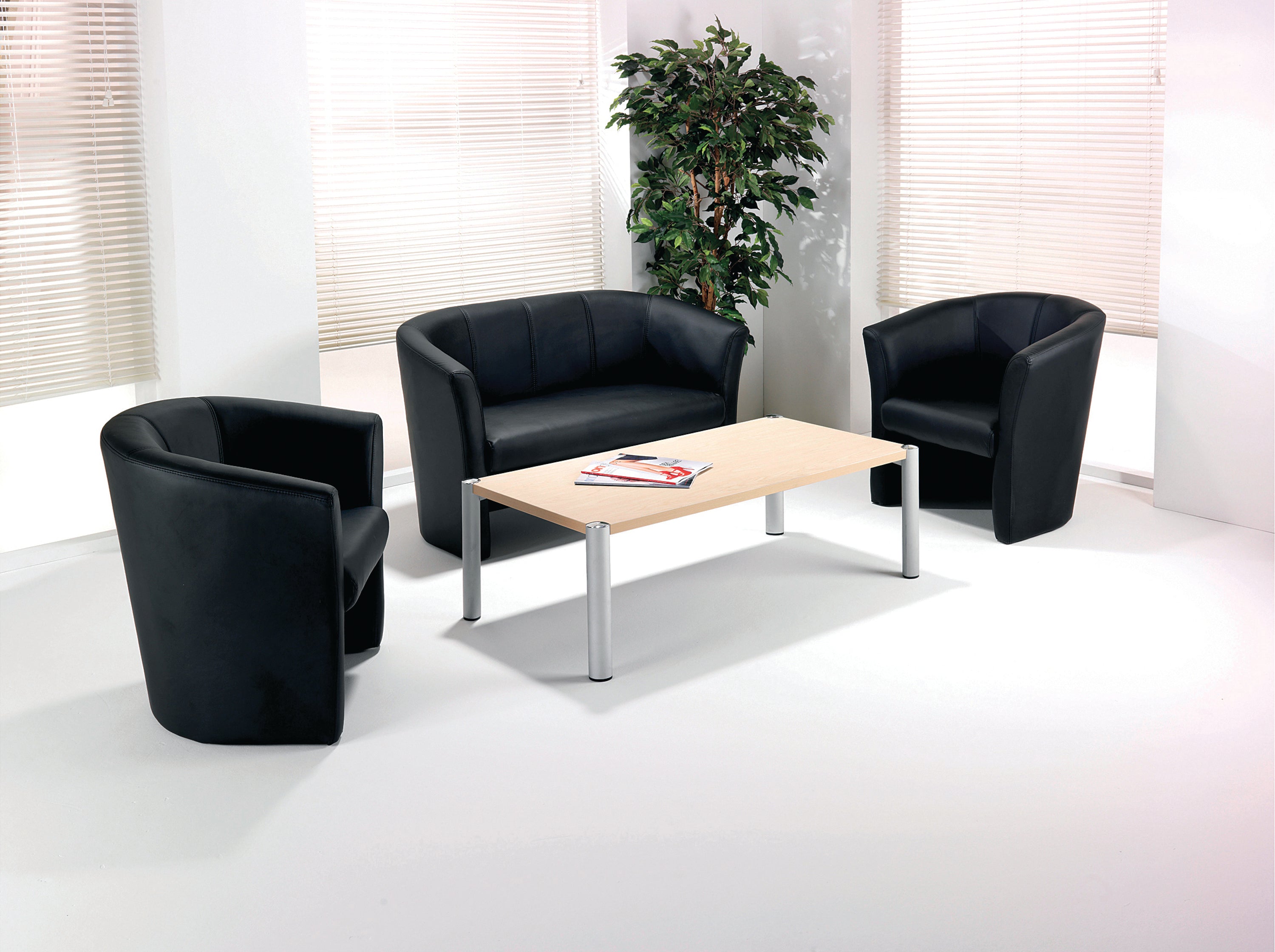 The Avior black vinyl tub chair positioned in a modern office reception area setting.