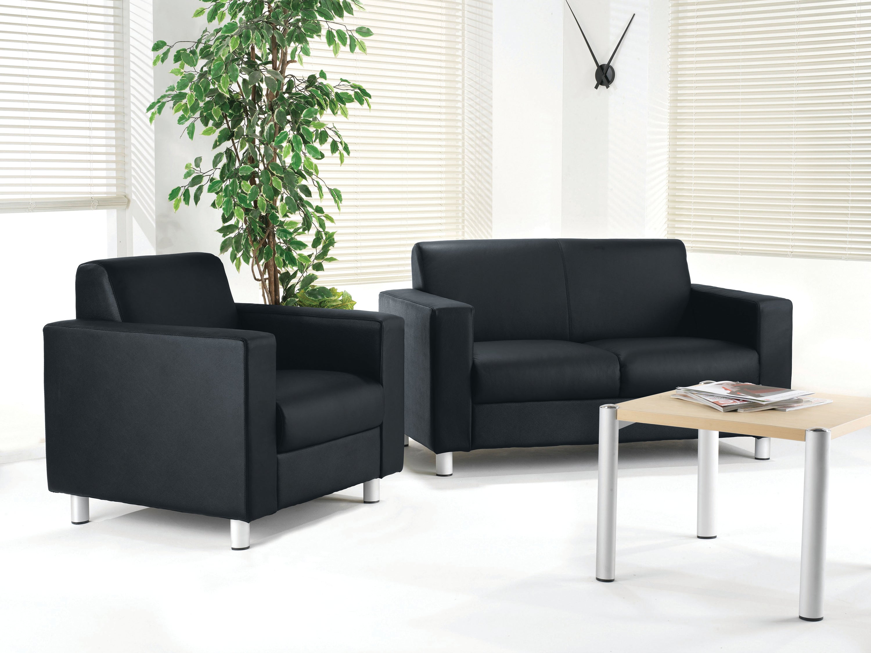 Detailed look at the stitching and plush cushioning of the Avior black leather reception sofa.