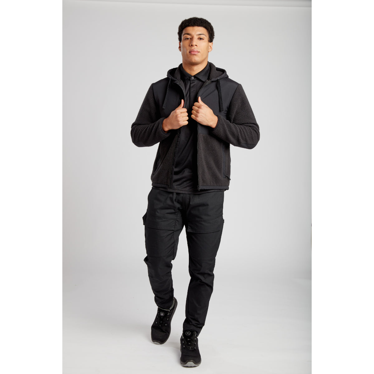 Model in an urban setting wearing the Portwest KX3 jacket and trouser combination.