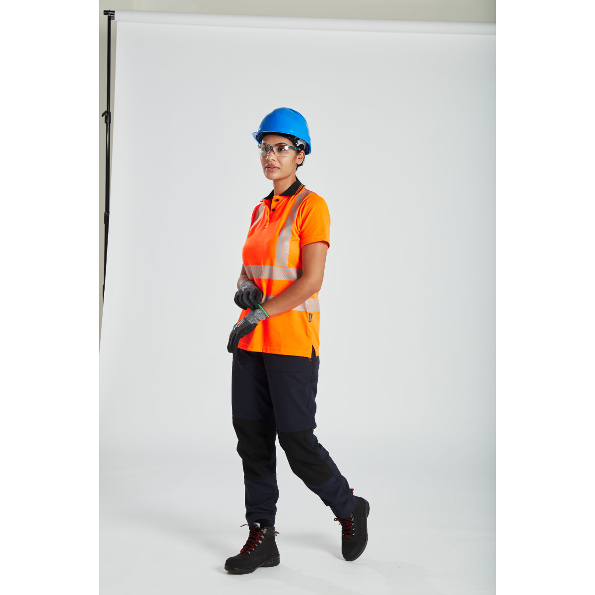 Construction worker in high-visibility gear wearing a Portwest safety helmet.