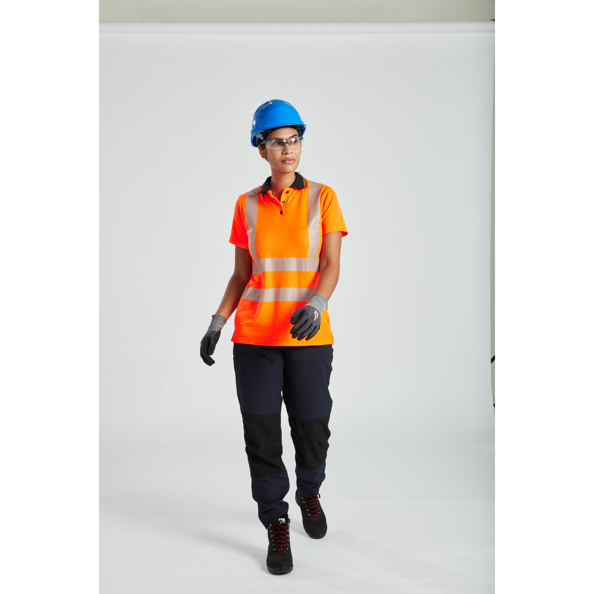 Worker wearing Portwest helmet and ear defenders while operating machinery.