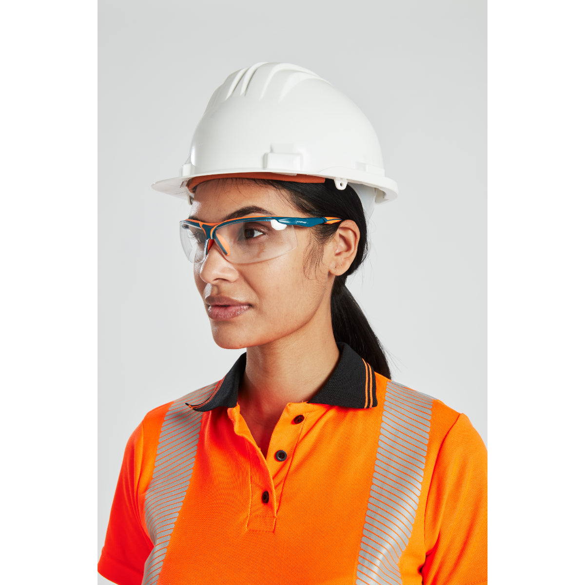 A worker wearing a Portwest safety helmet with clip-on ear protection.