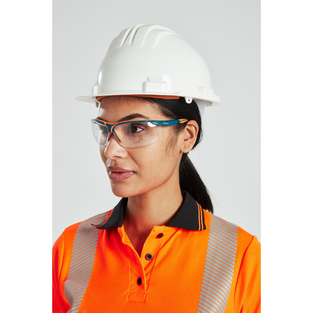 A worker wearing a white Portwest safety helmet and ear defenders.