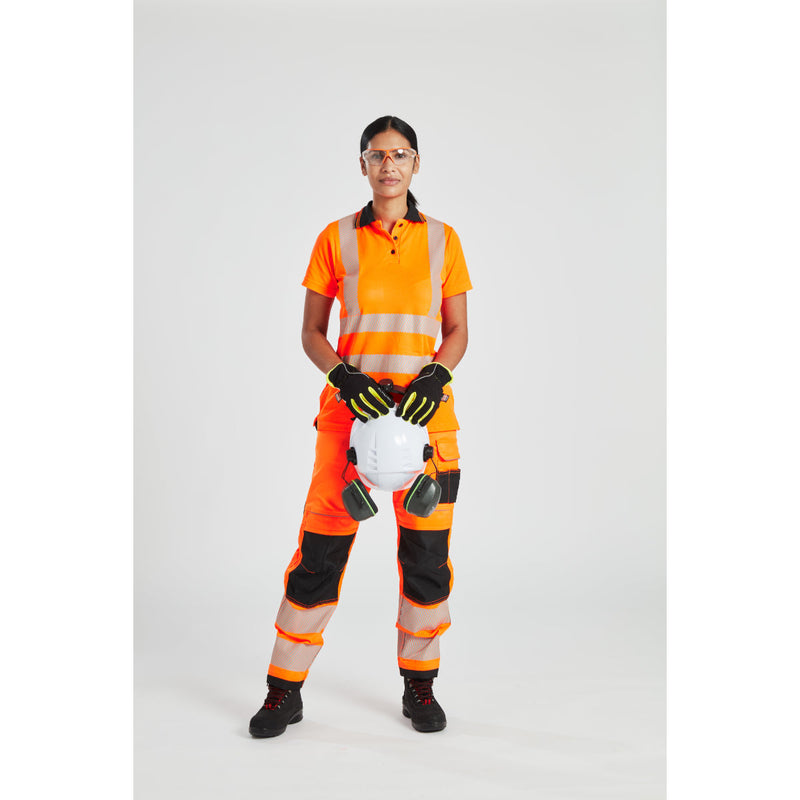 Two female workers in Portwest gear discussing work on a construction site.