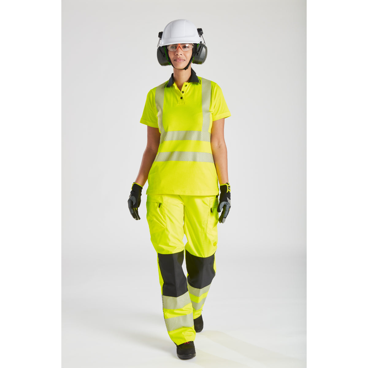 Model smiling while wearing the Portwest PW3 hi-vis women's rain jacket and trousers.