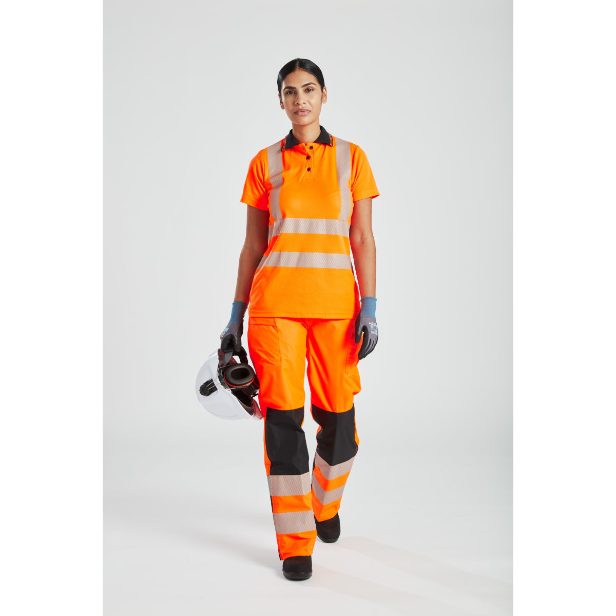 Rear three-quarter view of a model in the hi-vis women's rainwear.