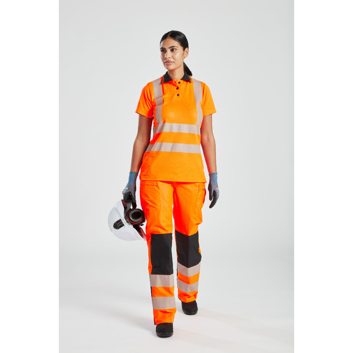 Front view of a model wearing the complete hi-vis women's rainwear outfit.