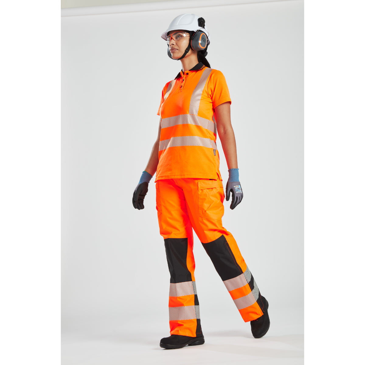 Model wearing the hi-vis women's rain trousers with a matching hi-vis softshell jacket.