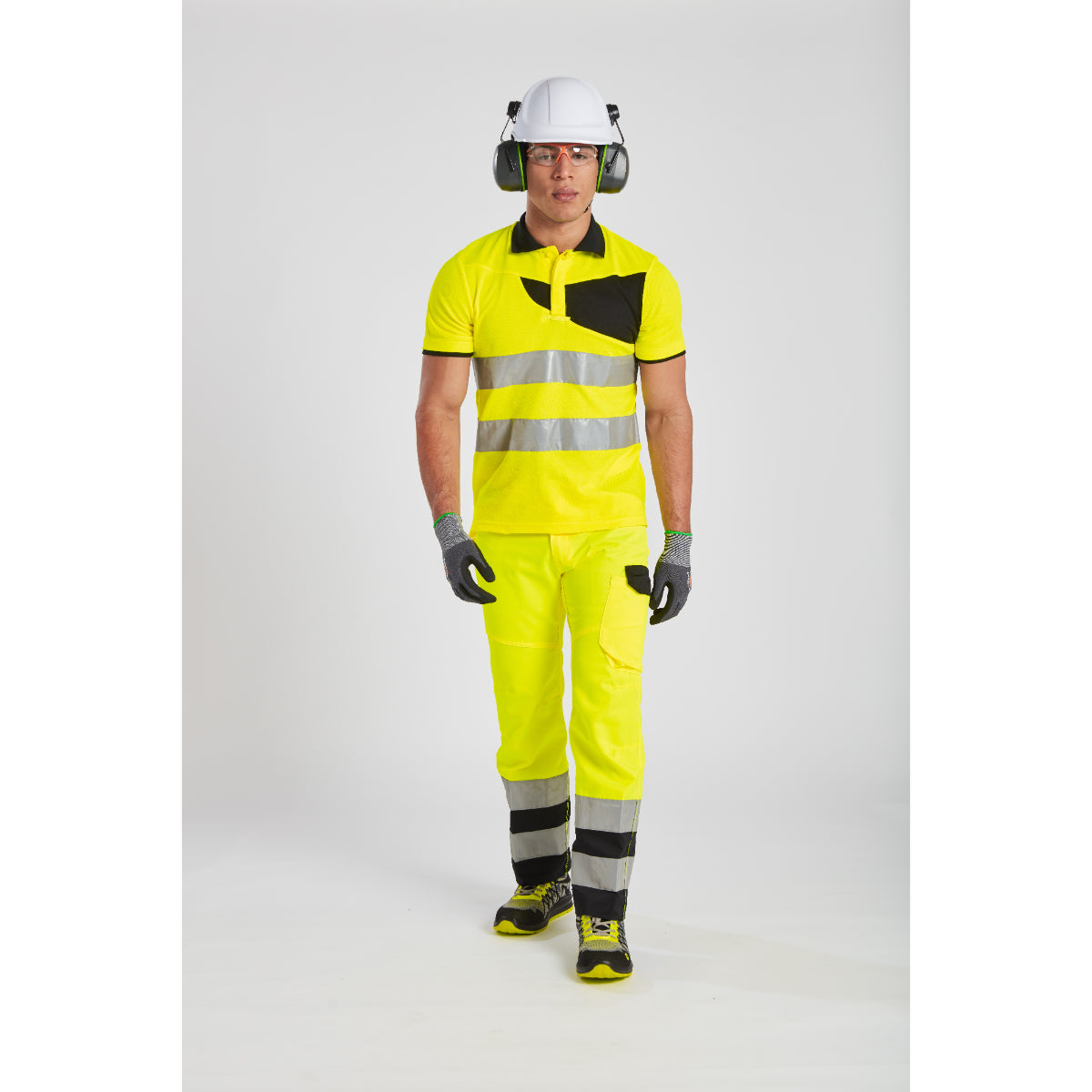 Worker wearing the hi-vis trousers and a matching polo shirt.