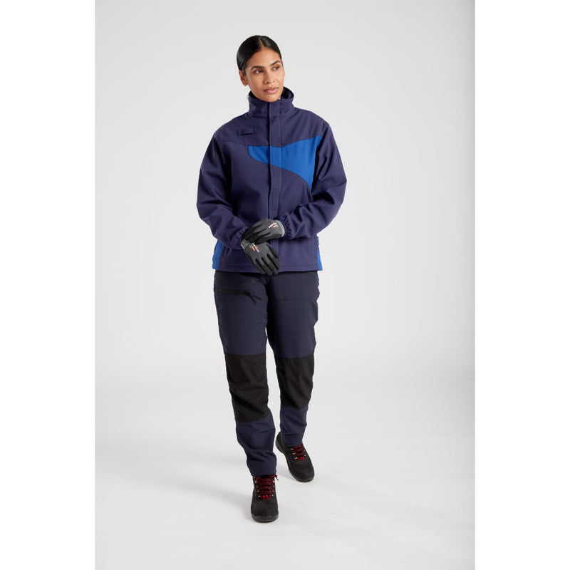 A female worker in stretch trousers and jacket, looking at plans.