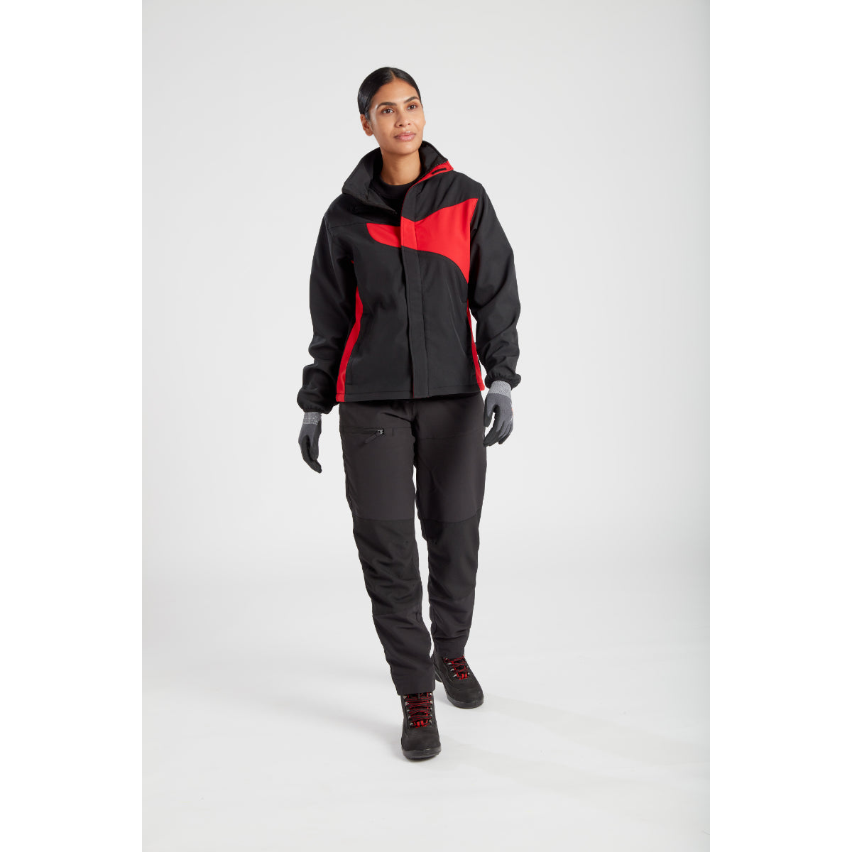 A woman confidently wearing the Portwest Softshell jacket.