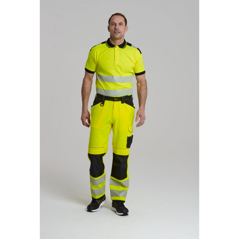 Side view of a model in the Portwest PW3 Hi-Vis Work Trouser.