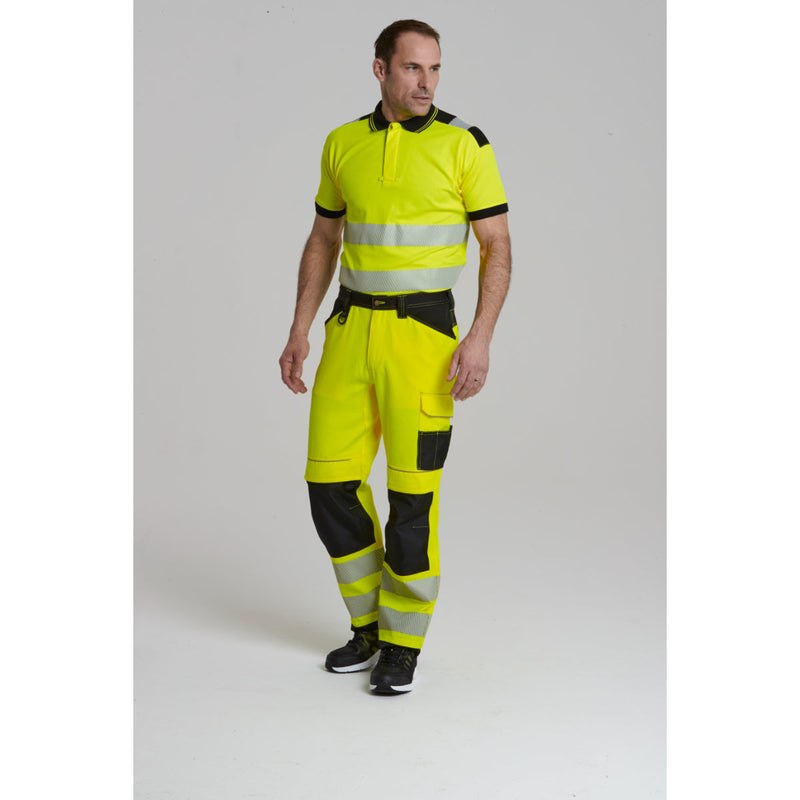 Rear view of a model in the Portwest PW3 Hi-Vis Work Trouser.