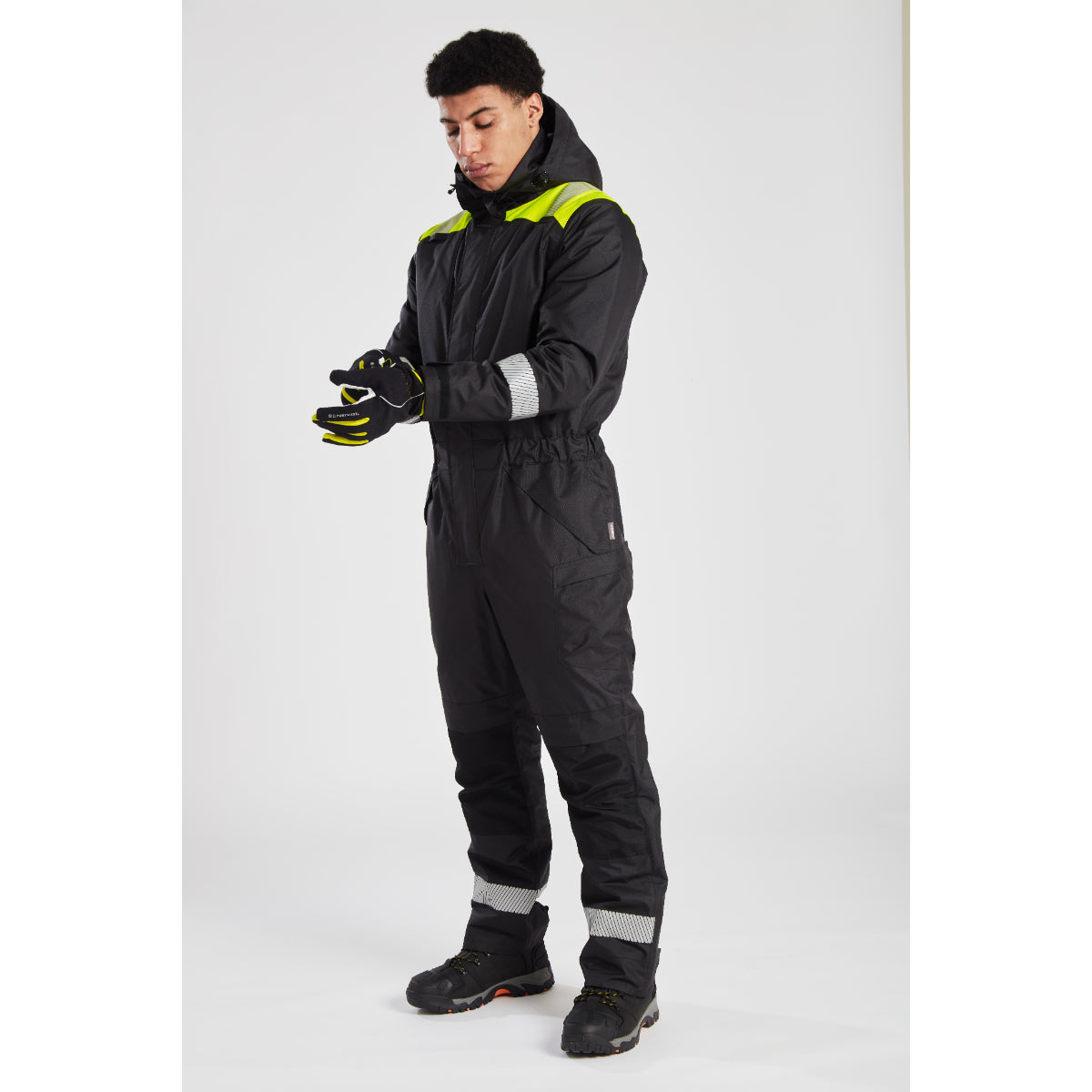 Side view of the grey and black Portwest PW3 Winter Coverall being worn by a model.