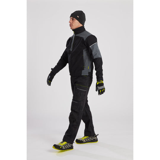 Model in an industrial setting wearing the Portwest PW3 jacket with matching work trousers and gear.

