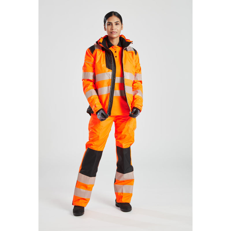 Side profile of a woman wearing the orange Portwest PW3 Hi-Vis Winter Jacket.