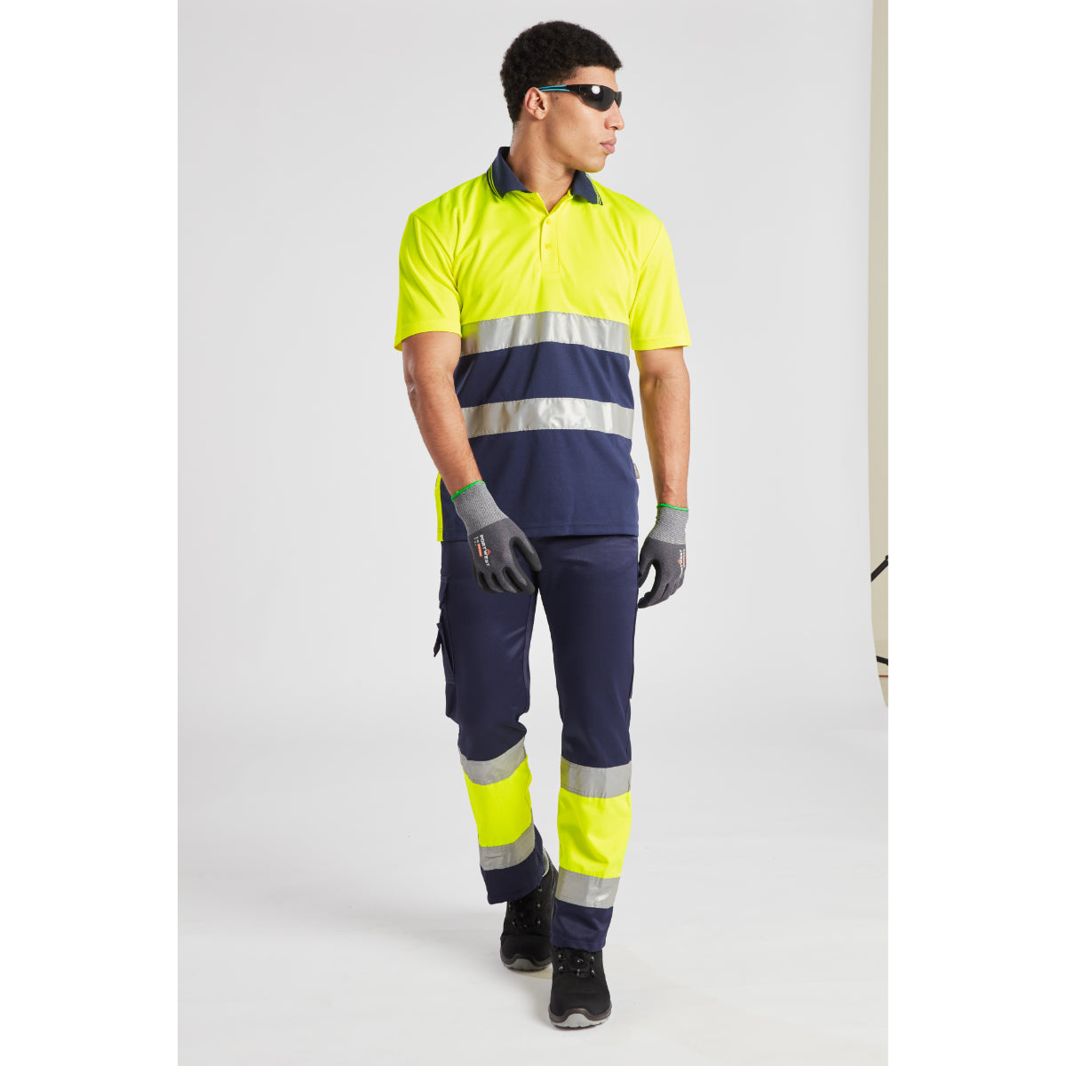 Side view of a model in the Portwest Hi-Vis Lightweight Trouser, showing cargo pocket.