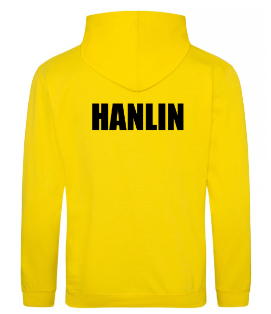 A focused composition on the embroidered Armadale PS crest on a yellow kids' hoodie.