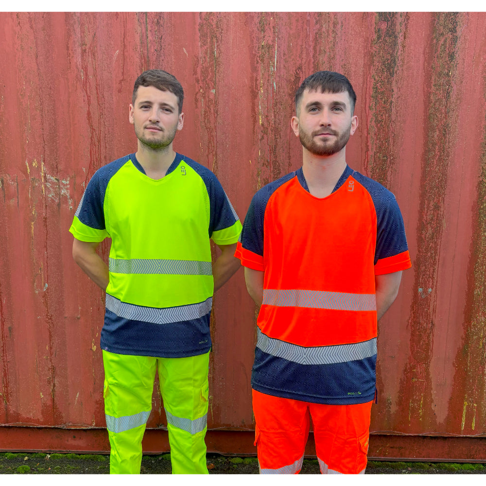 Front view of two men in Leo EcoViz T-shirts, yellow and orange variants, posing against red wall.