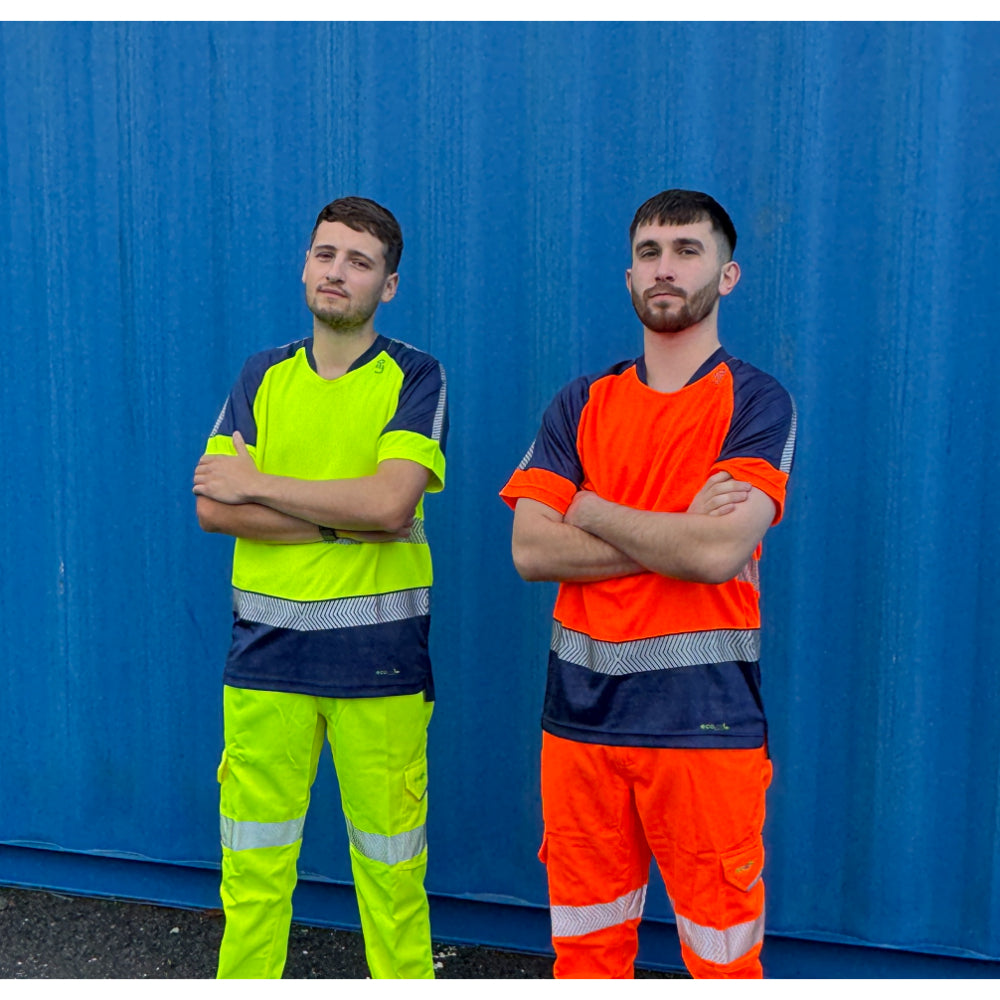 Two workers in yellow and orange Leo EcoViz Performance+ T-shirts standing by blue wall.