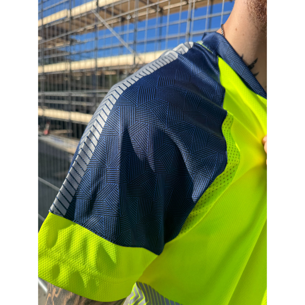 Close-up of Leo Workwear EcoViz T-shirt shoulder showing reflective strip and geometric design.